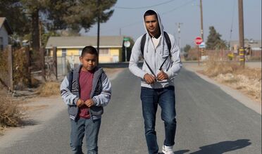 Two students walking down the street.